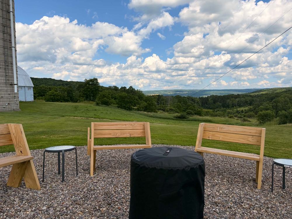 Benches around the fire pit looking out over the valley