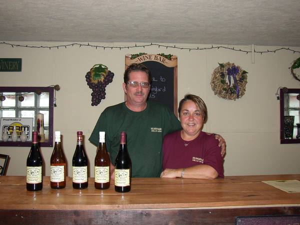Ken and Kimm at the wine bar with a lineup of bottles