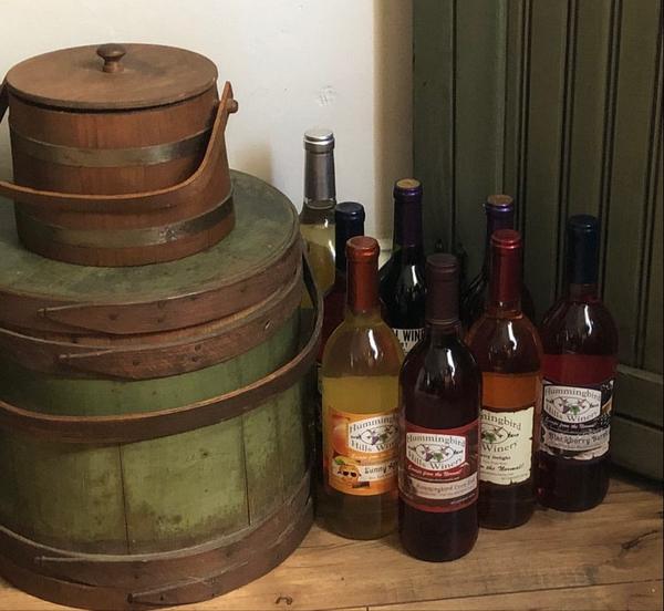Bottles beside antique wooden firkins