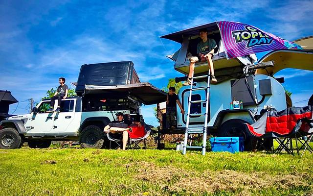 Jeeps and rooftop tents set up for a weekend on the farm