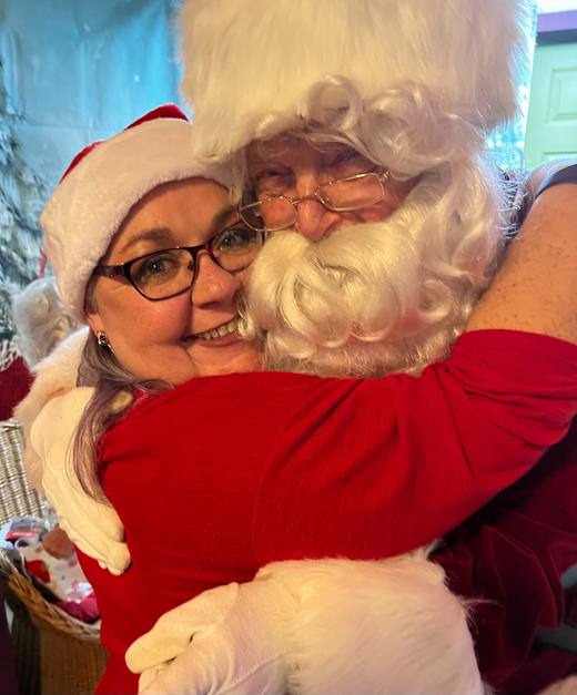 Kimm and Santa sharing a hug at the winery's Christmas event