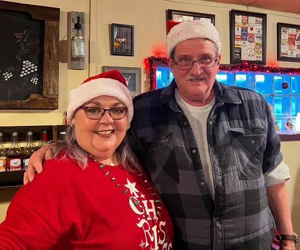 Kimm and Ken behind the bar at Christmas
