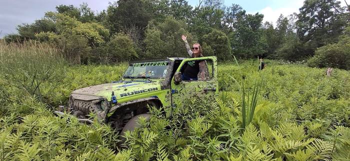 A muddy Jeep Rubicon out on the trails during the Jeep event