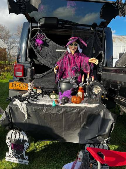 A witch and cauldron set up in the back of a Jeep