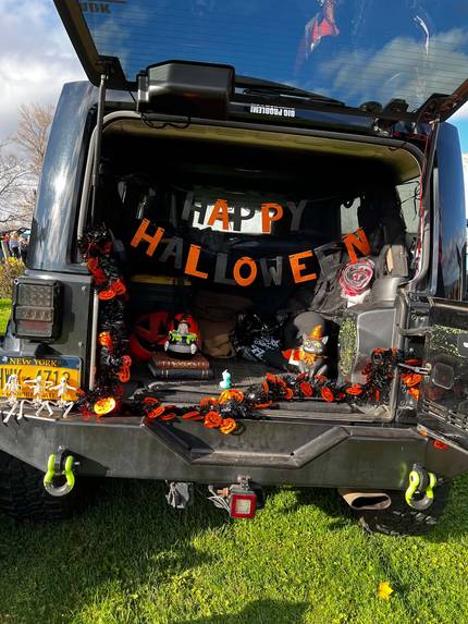 A Jeep trunk decked out with a Happy Halloween banner